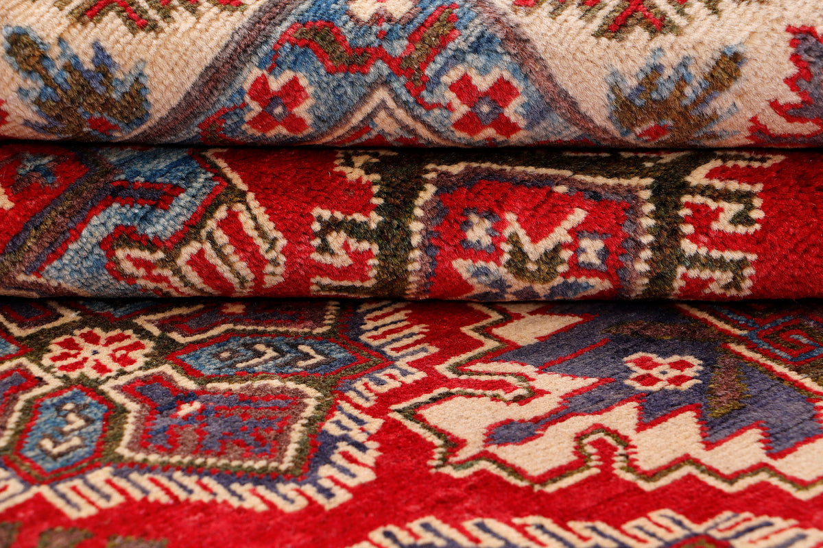 Close-up of folded rug edge with multicolor geometric pattern and textured pile
