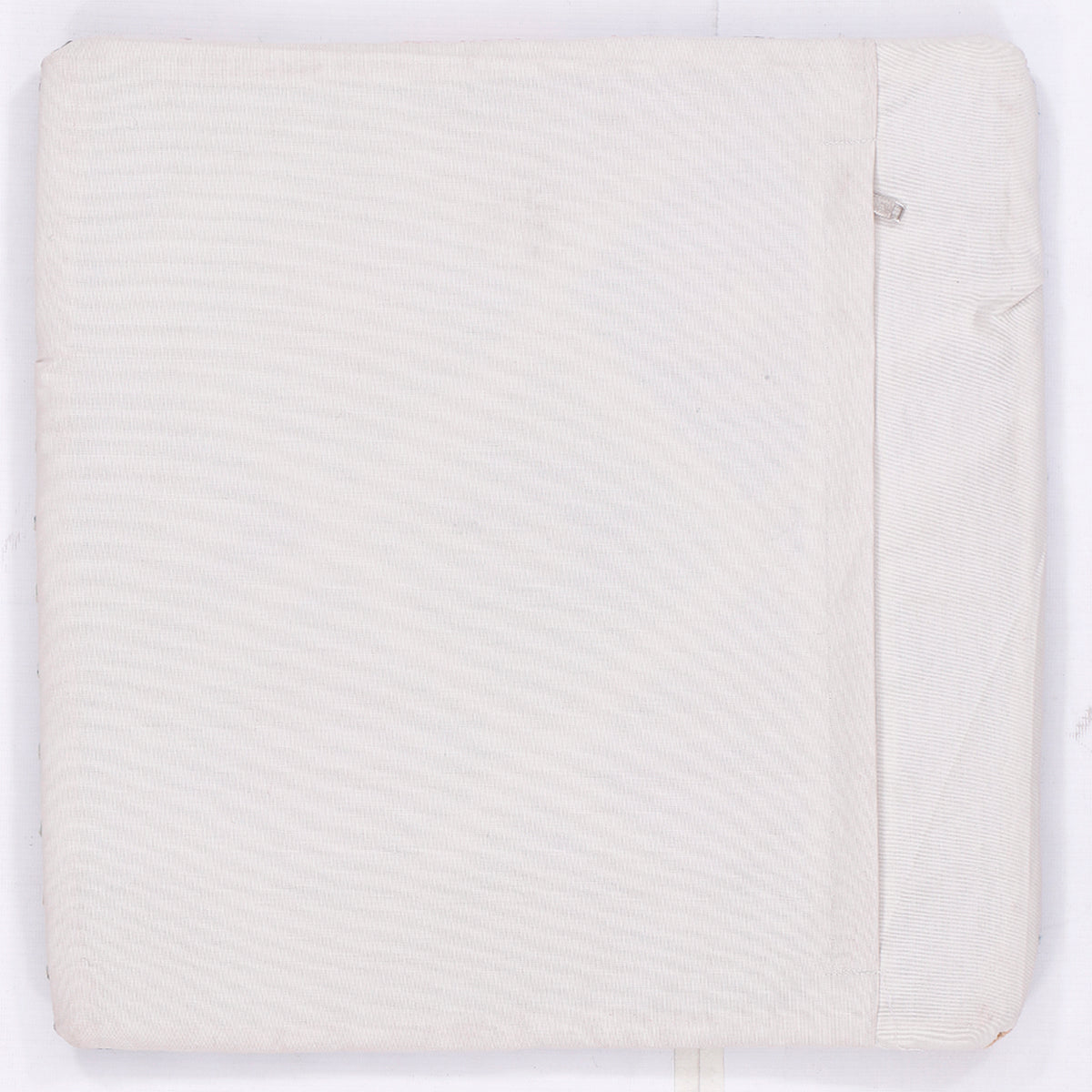 Off-white kilim cushion cover back with subtle textured weave and edge seam