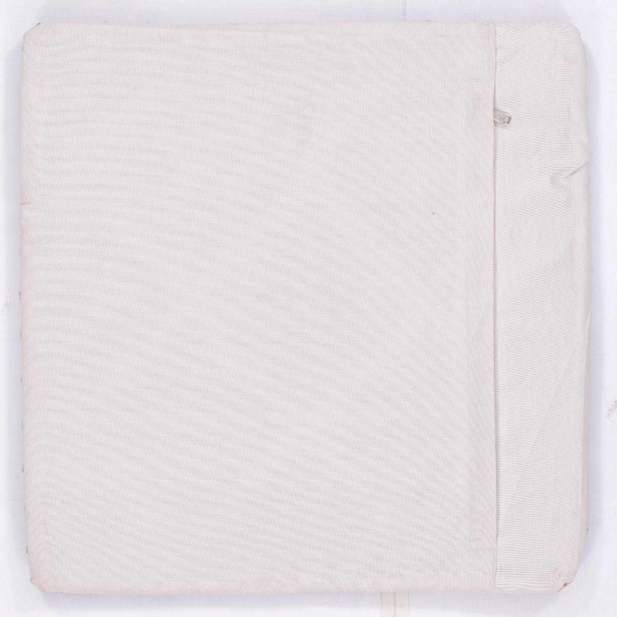 Off-white kilim cushion cover back with visible seam and bordered edge