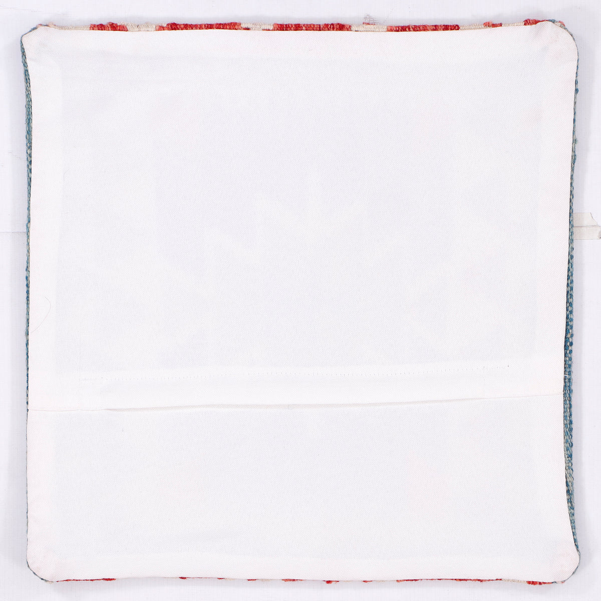 White kilim cushion back with red and blue stitched border