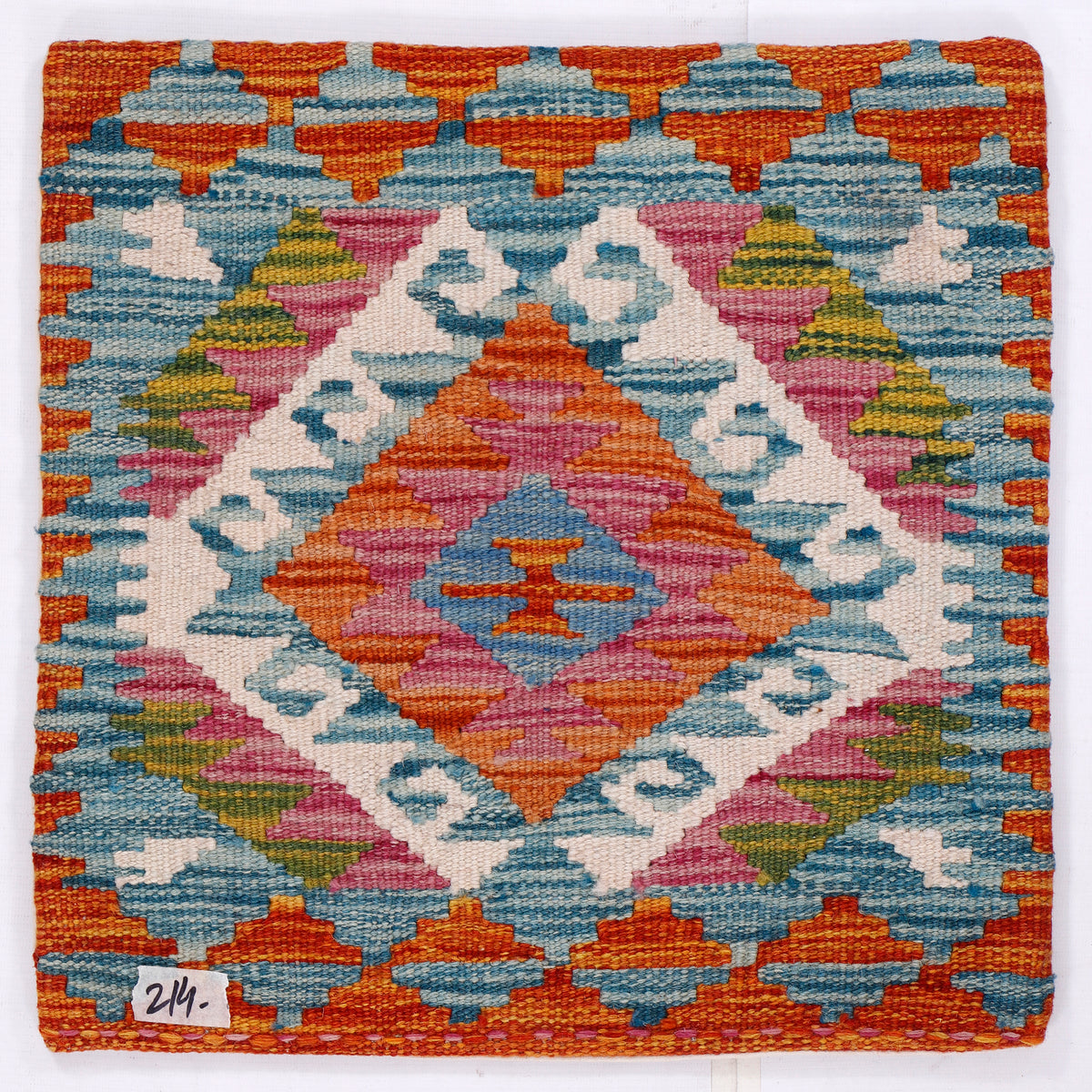 Blue kilim cushion cover close-up with layered multicolor geometric diamond pattern