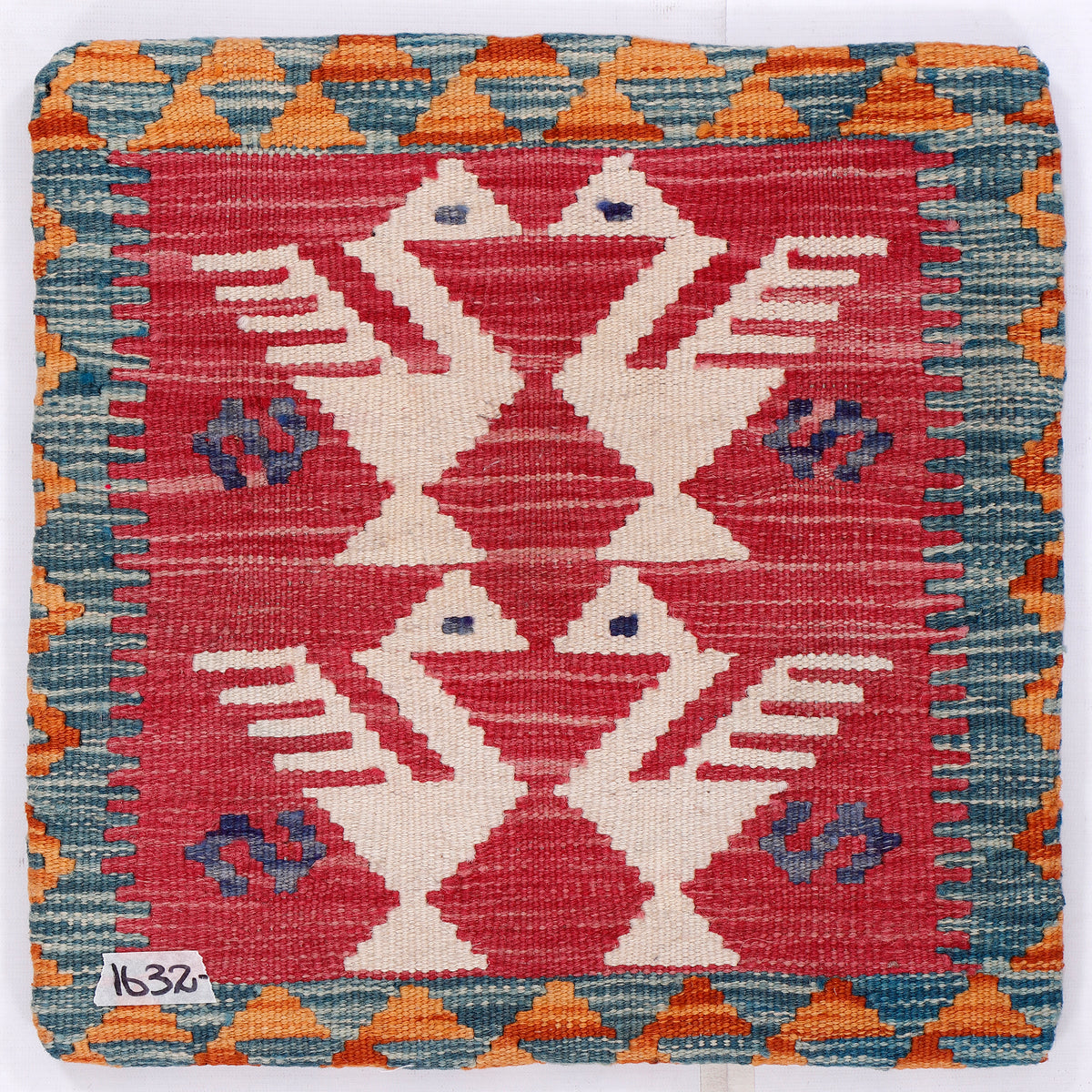 Kilim cushion cover close-up with red, blue, cream bird motif pattern