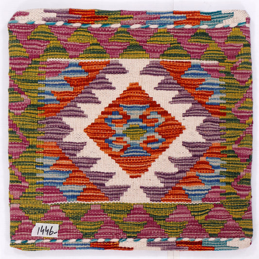 Close-up kilim cushion front with orange medallion and purple, blue, yellow woven pattern