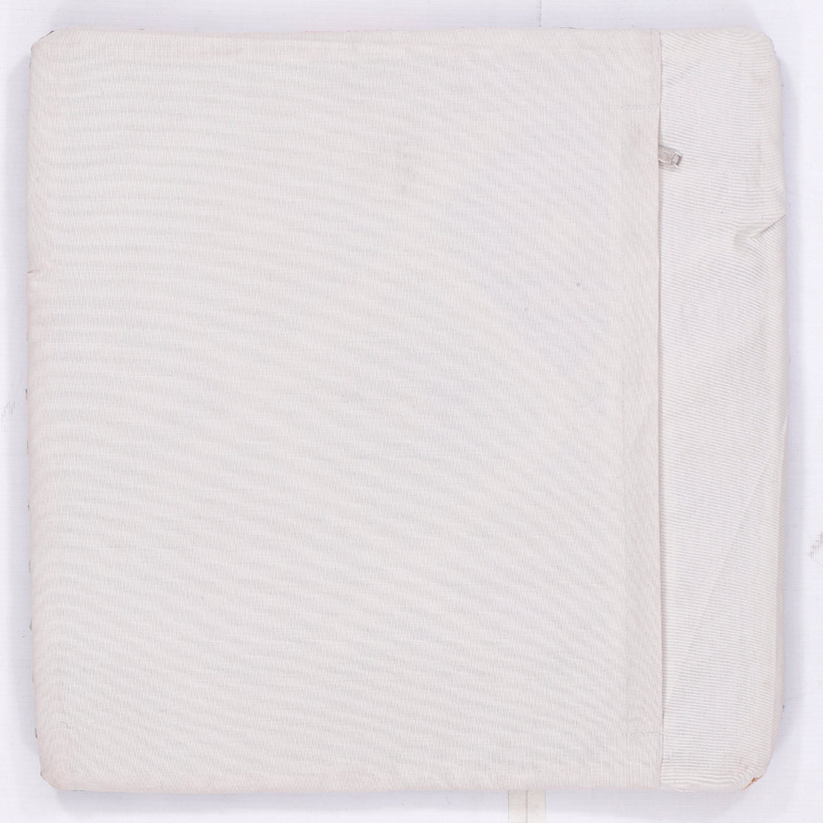 Square cushion cover, plain off-white fabric with side seam and corner fold
