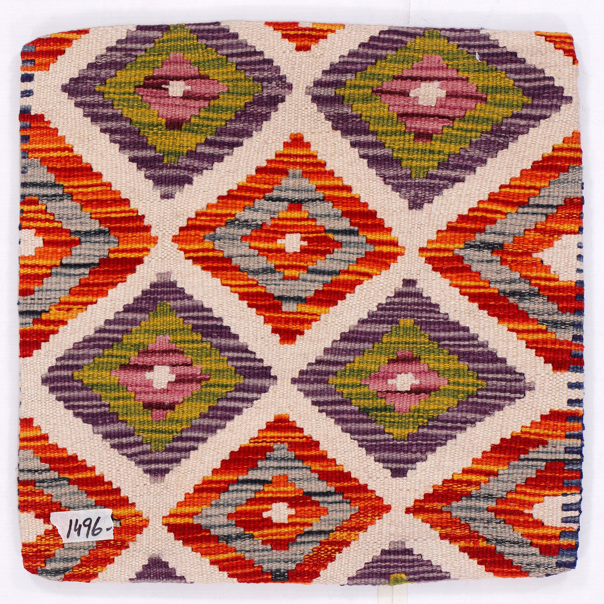 Kilim cushion cover close-up with multicolor diamond pattern on cream background