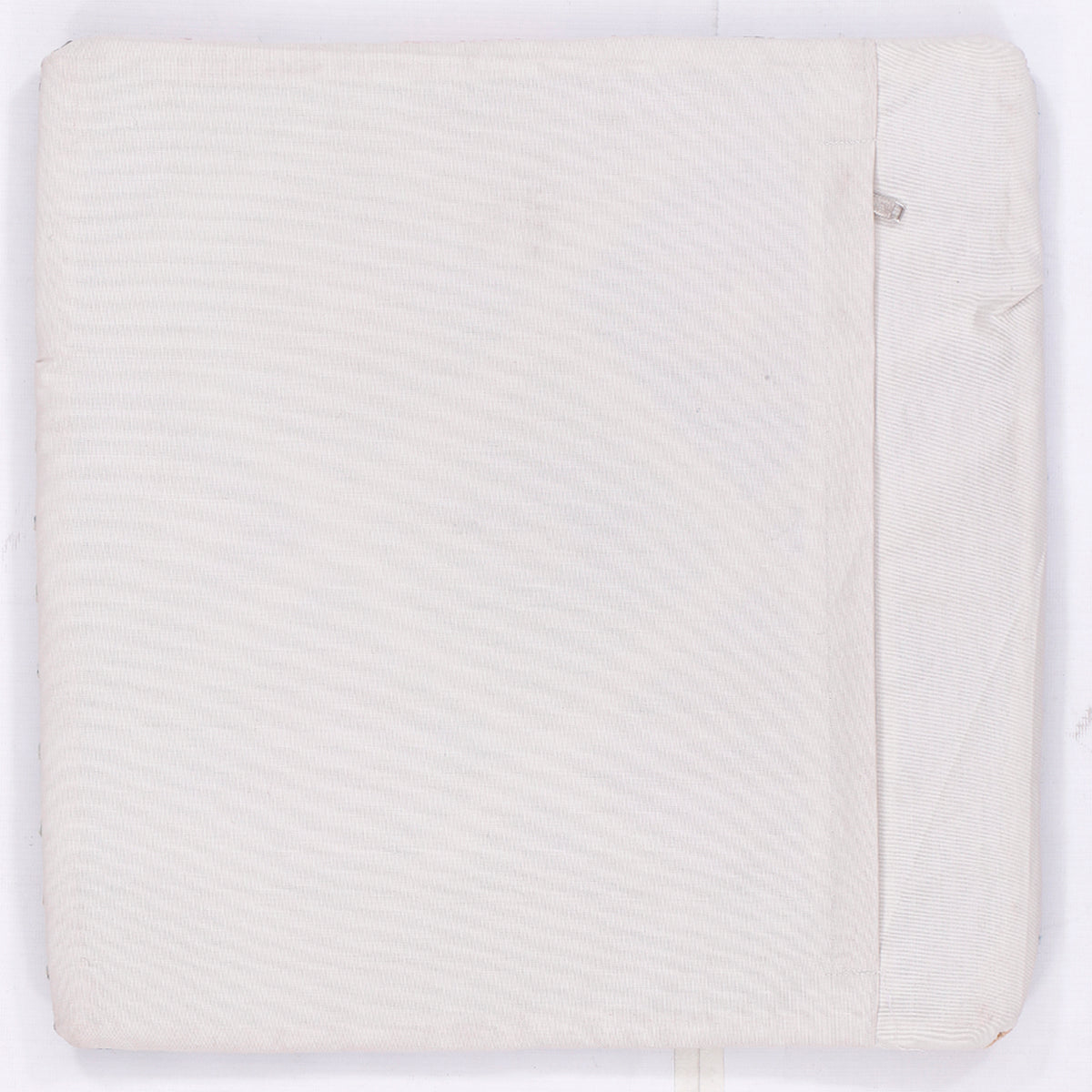 Square cushion back panel in light cream with subtle woven texture