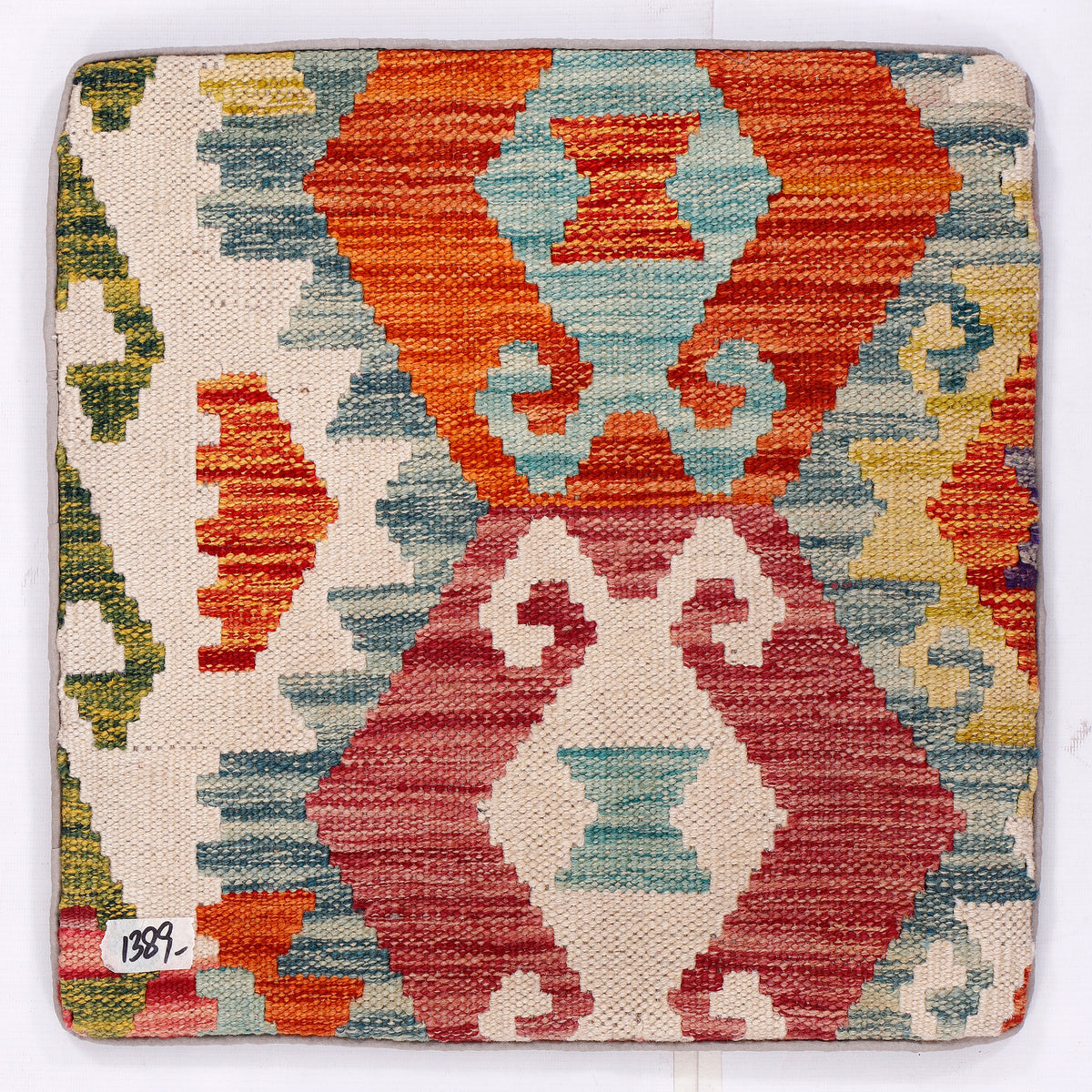 Tribal kilim cushion with geometric pattern, cream base, orange and blue red blocks