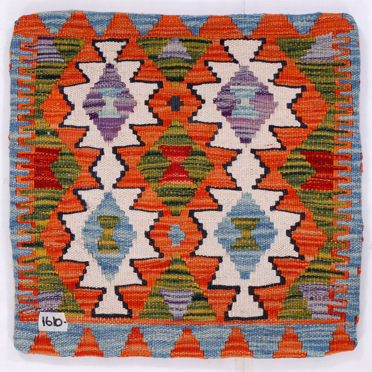 Kilim cushion cover front with repeating orange, blue, and green geometric pattern