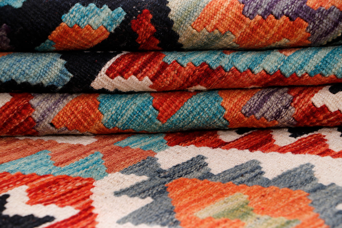 Kilim rug with multicolor geometric zigzag pattern in black, teal, orange, and red