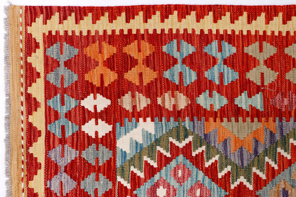 Kilim rug close-up border with red, blue, and orange diamond motif weaving