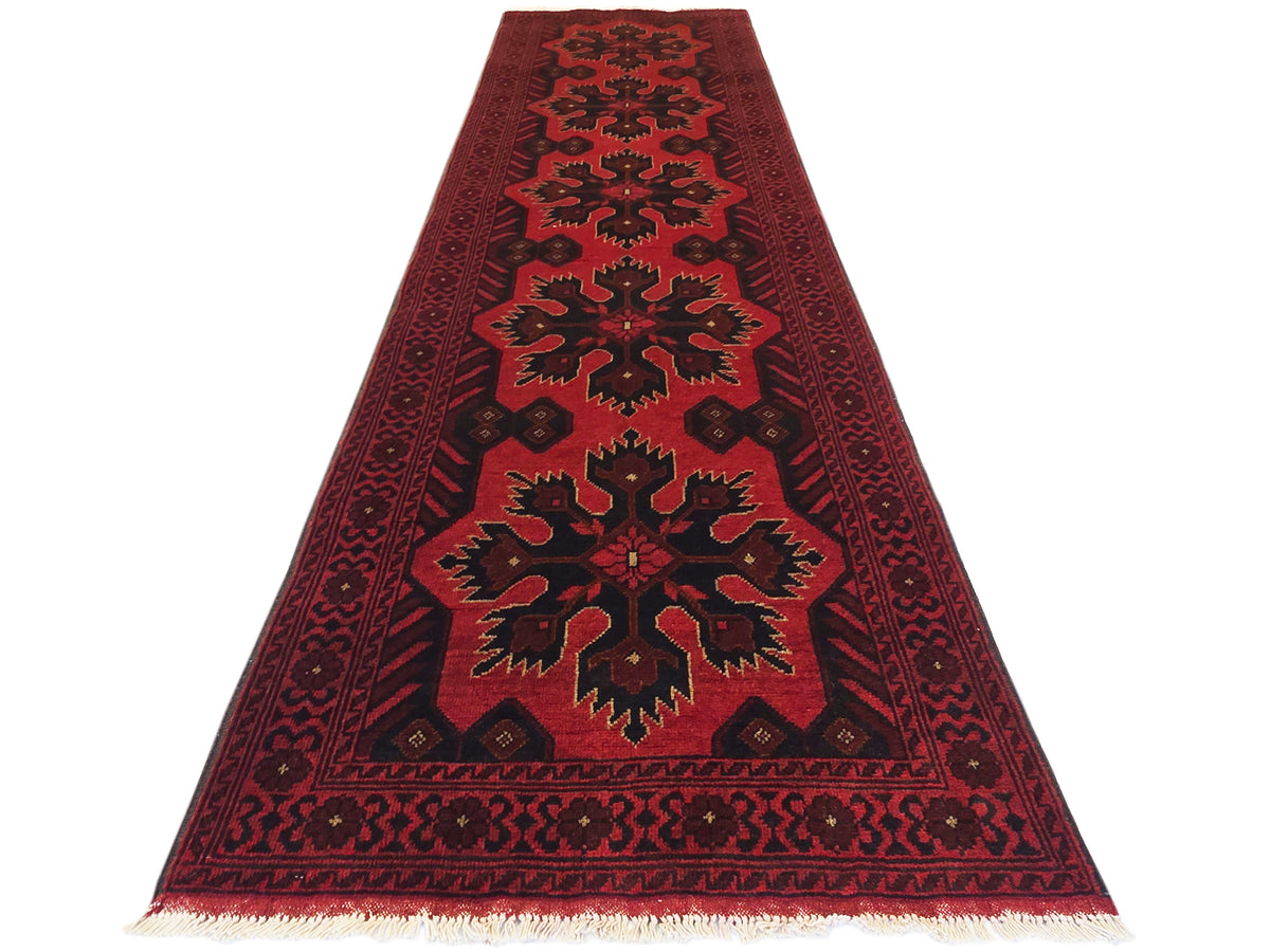 Maroon 290x79 rug with central starburst medallion, geometric border, and fringe ends