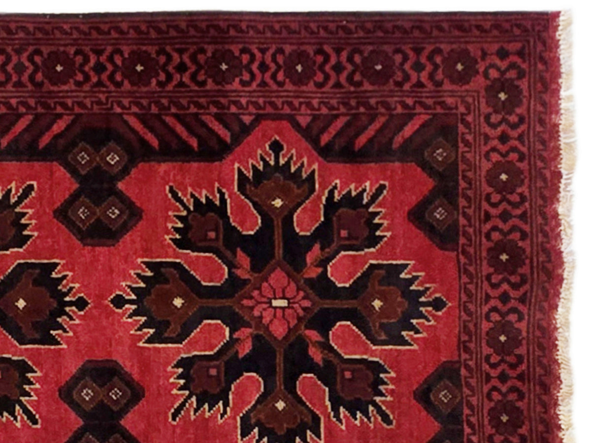 Maroon 290x79 rug close-up with dark geometric border and central star medallion