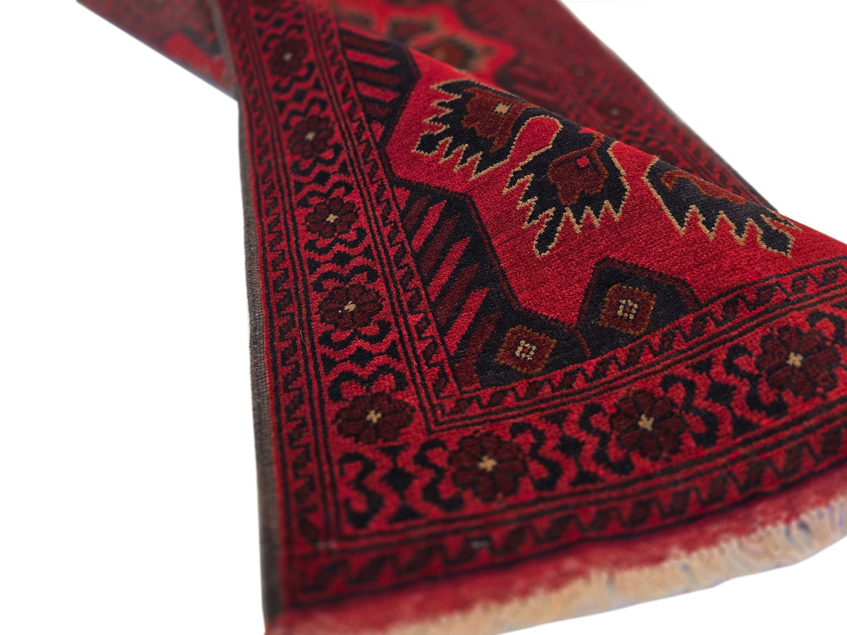 Maroon 290x79 rug corner with ornate geometric border and cream fringe detail