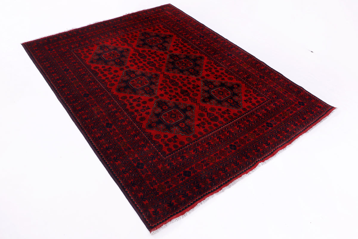 Red rectangular rug with central medallion and ornate geometric border