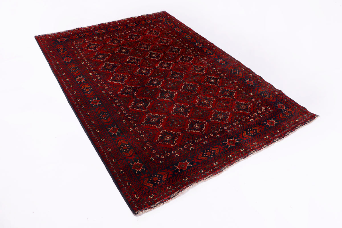Red geometric area rug with ornate pattern and angled corner