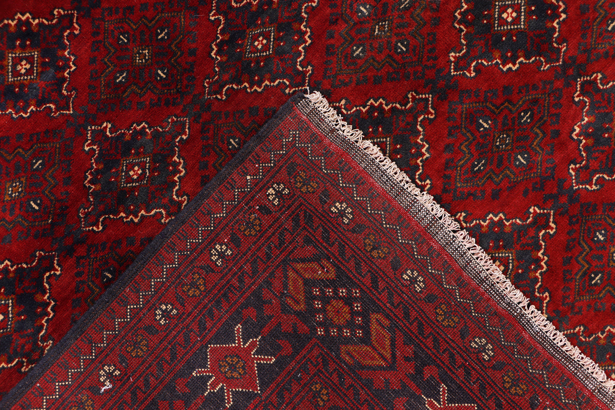 Red rug corner with decorative border and fringed edge detailing