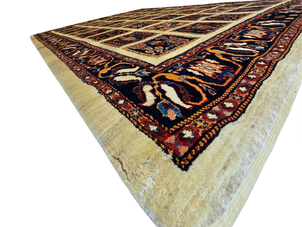Loribaft rug, corner view, navy and rust patterns on beige background