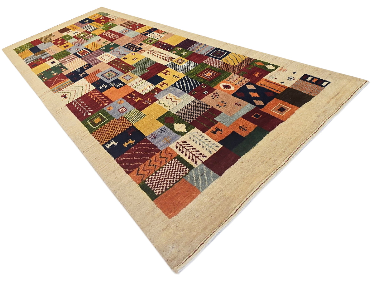 Loribaft patchwork rug featuring multicolor blocks and geometric motifs on beige.