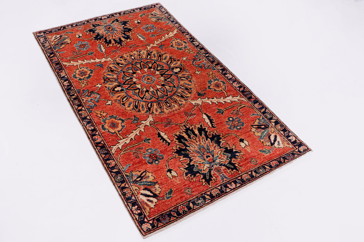 Red patterned area rug with central medallion and dark ornamental border