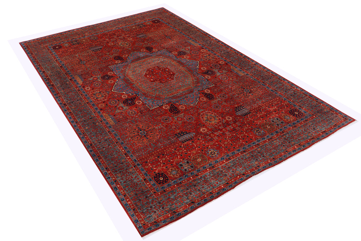 Top view of red traditional wool rug with central medallion and blue border
