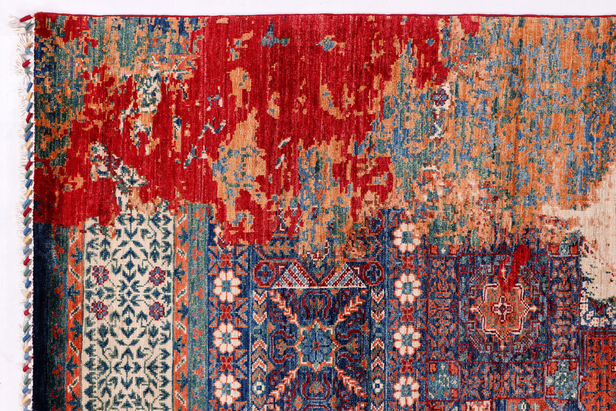 Close-up kilim rug with red field and blue geometric panels, distressed texture