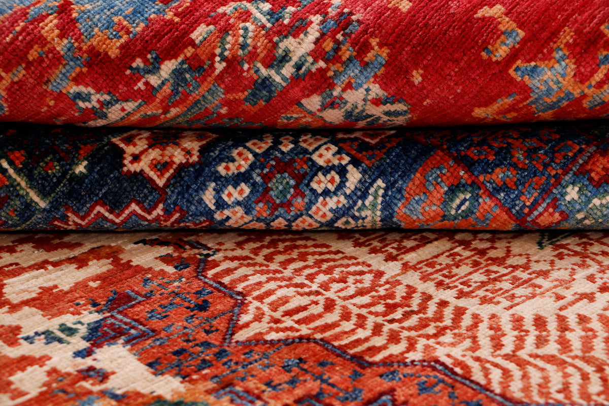 Kilim rug close-up with red motifs and dark blue border, worn texture