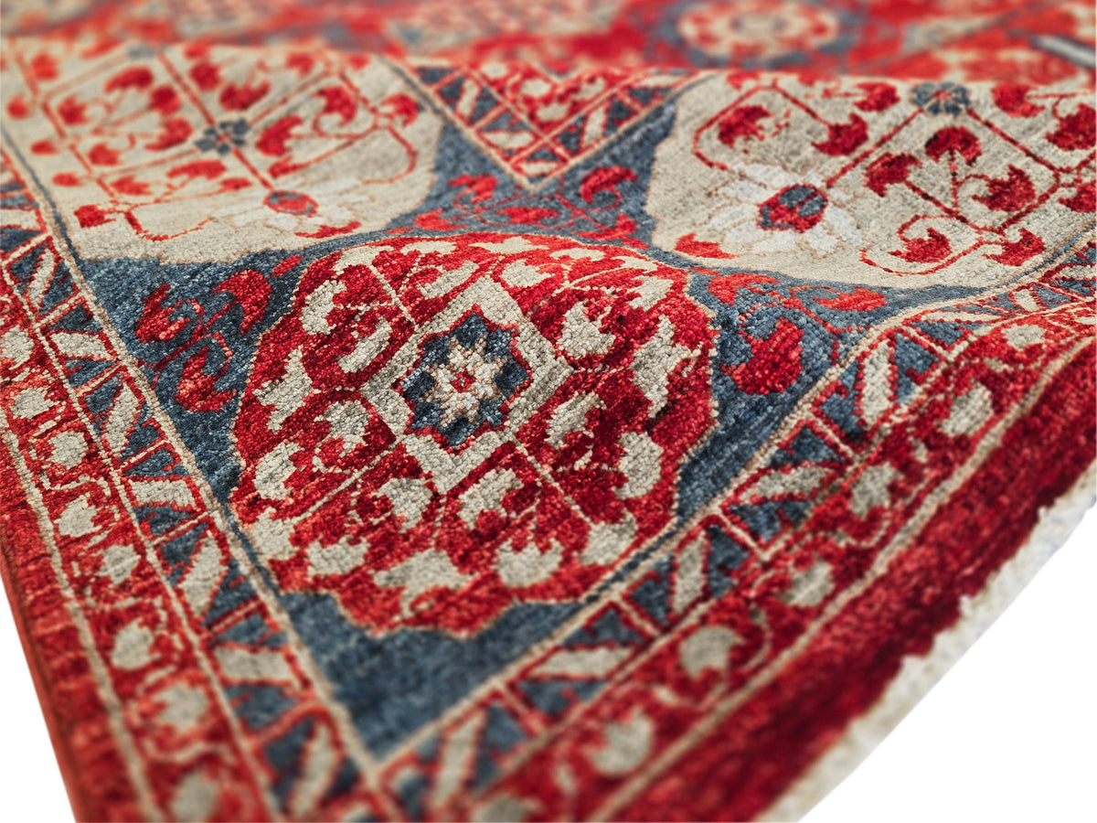 Mamluk rug texture close-up with red and blue highlights and cream geometric ornament