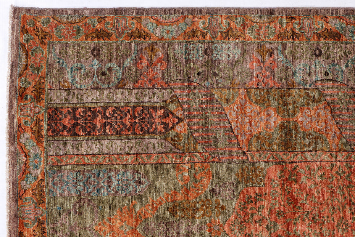 Distressed multicolor rug surface with geometric motifs in rust, teal, olive, and taupe.