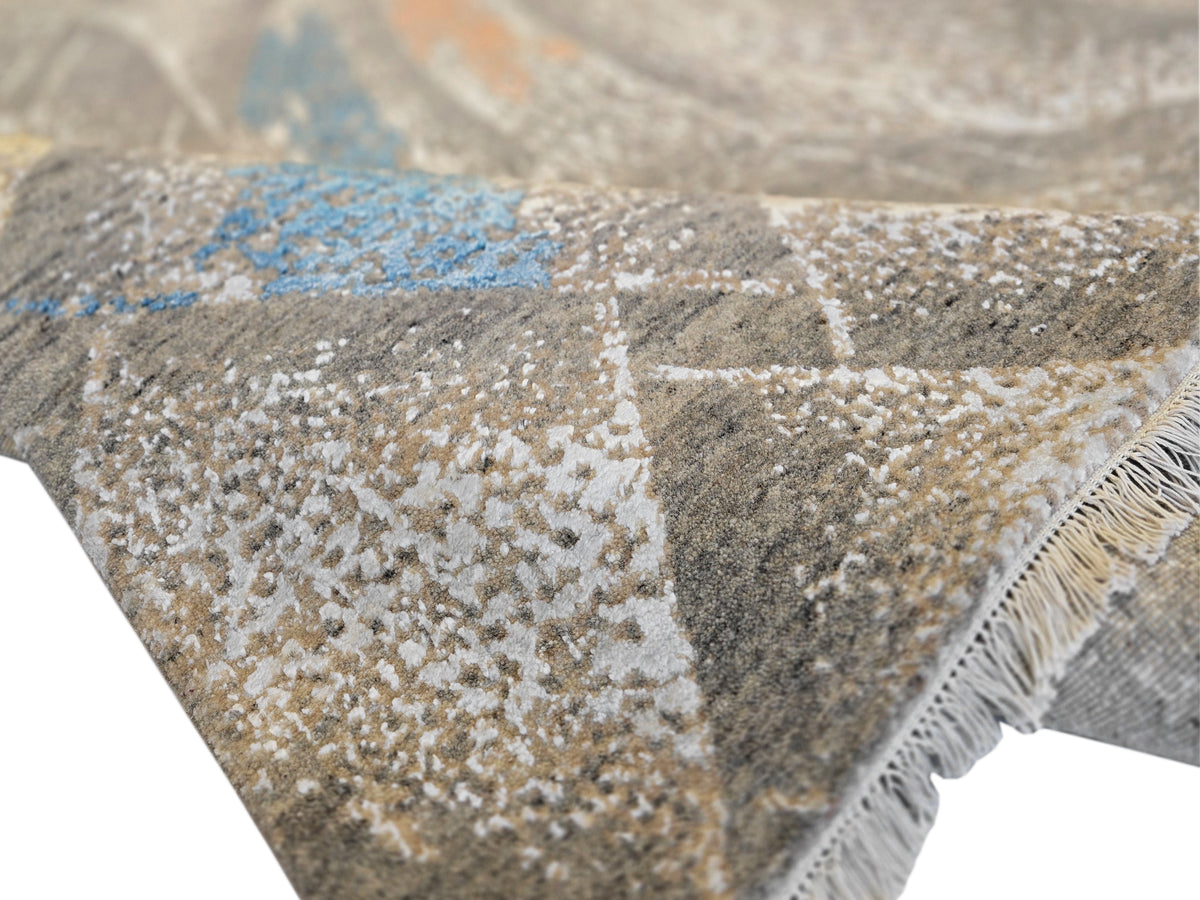 Modern abstract rug with short fringe edge and speckled beige, gray, and blue pattern