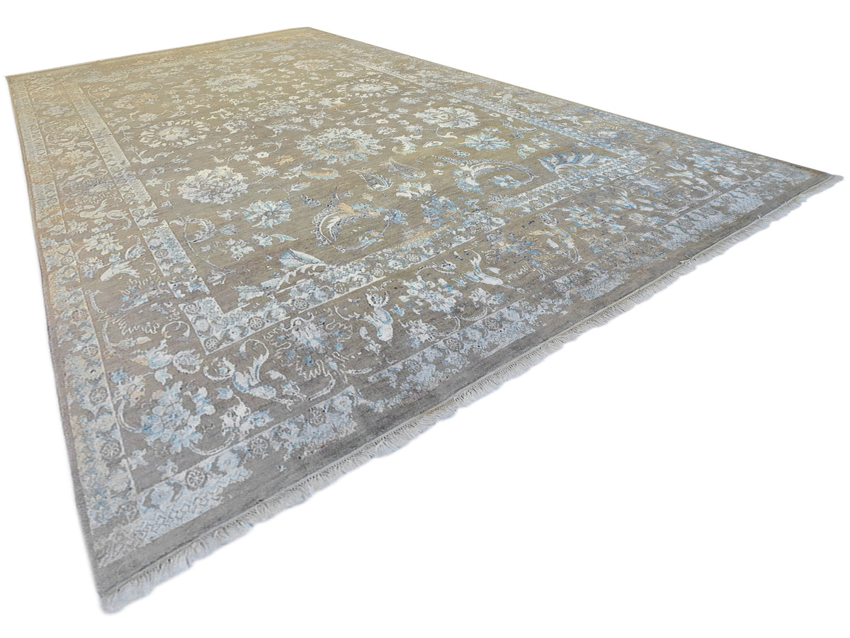Modern area rug with faded floral pattern and decorative border, beige and blue