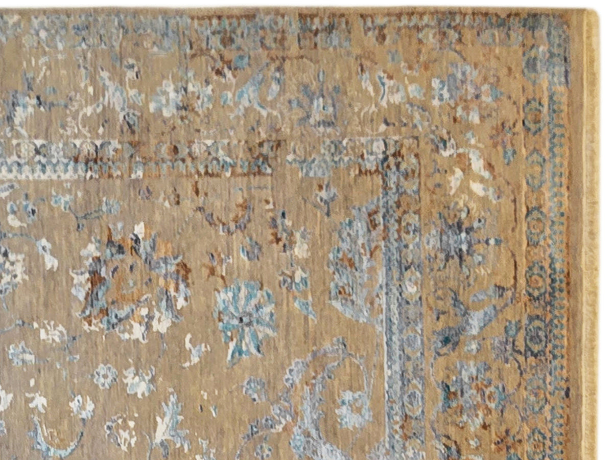 Close-up of distressed rug design with floral pattern, beige ground and blue accents