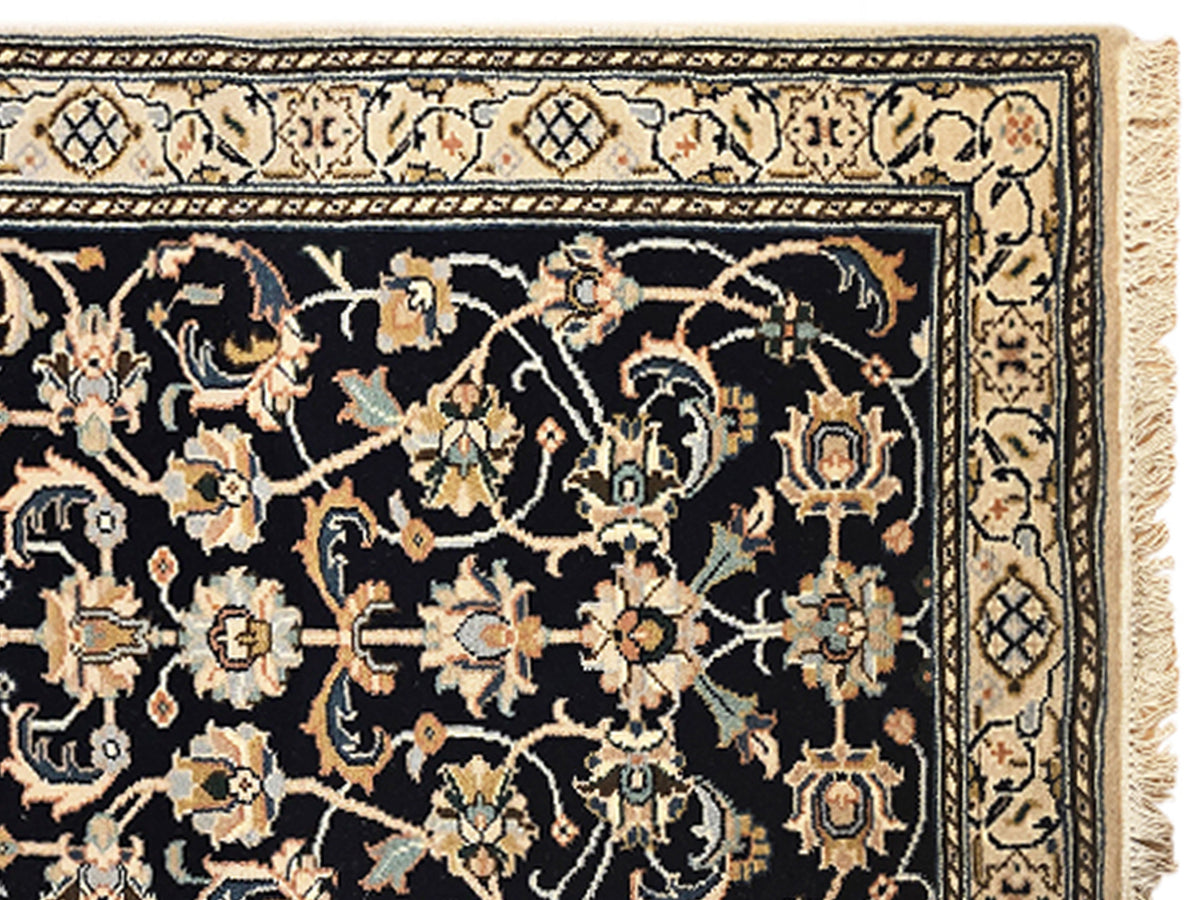 Nain rug 599x81 cm close-up of navy floral pattern with gold accents and cream geometric trim
