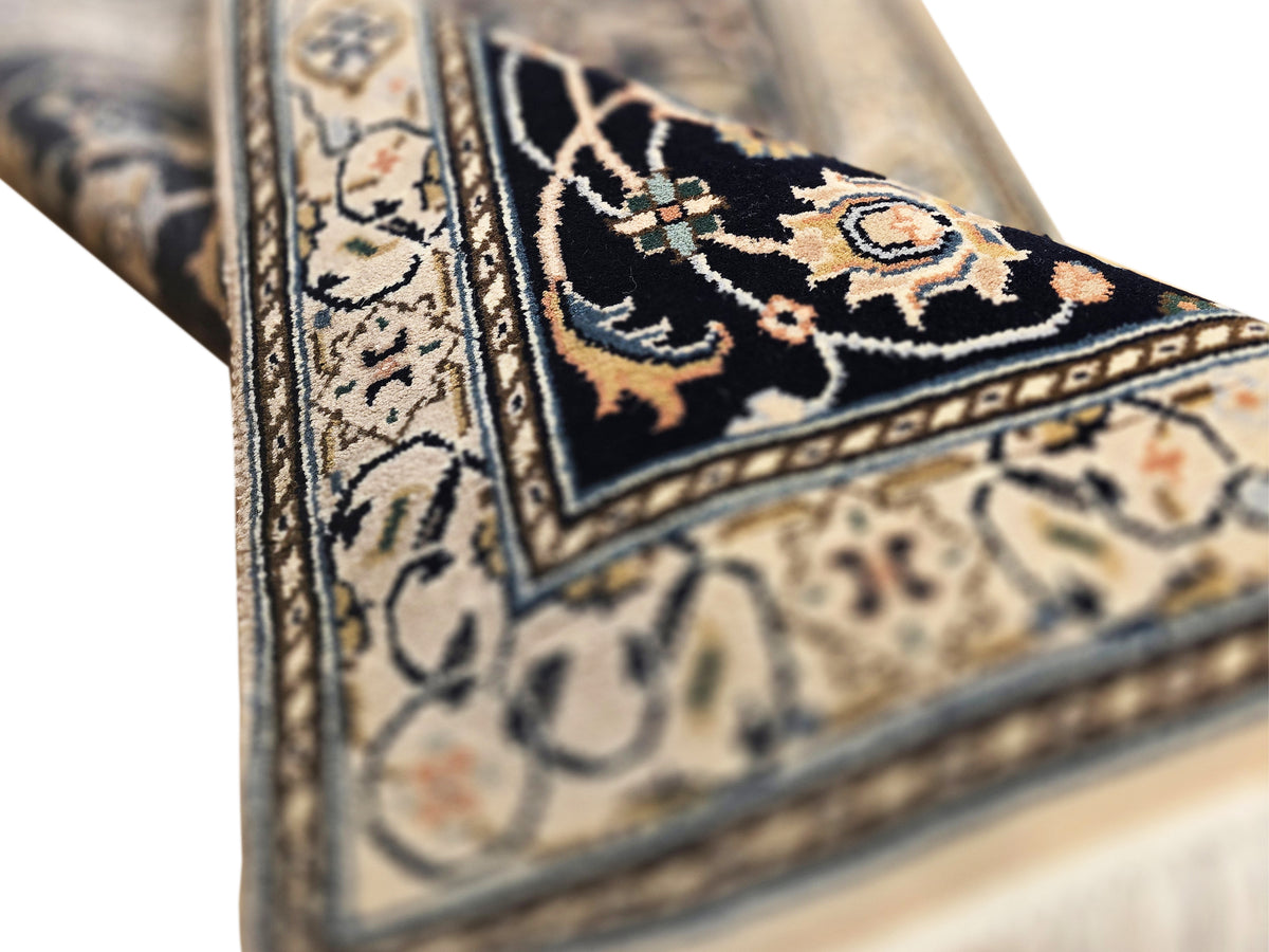 Nain runner rug corner, dark navy motif on cream ground with gold details, short tassel fringe