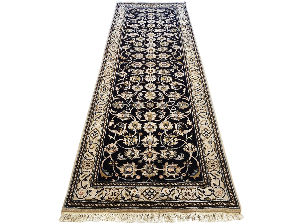 Navy/black runner rug with detailed gold and cream floral scroll border and fringe