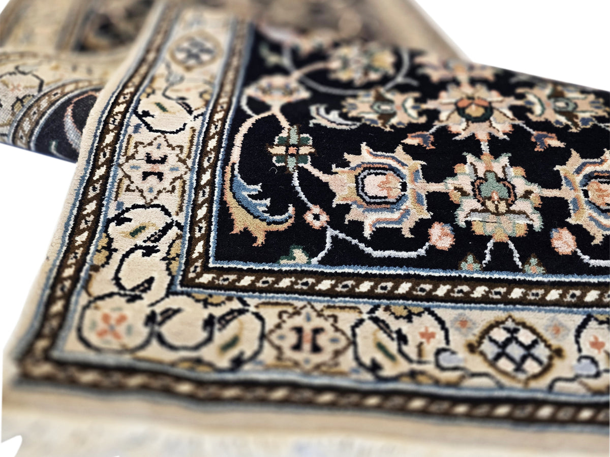 Close-up of runner rug texture and central medallions in black, gold, and cream