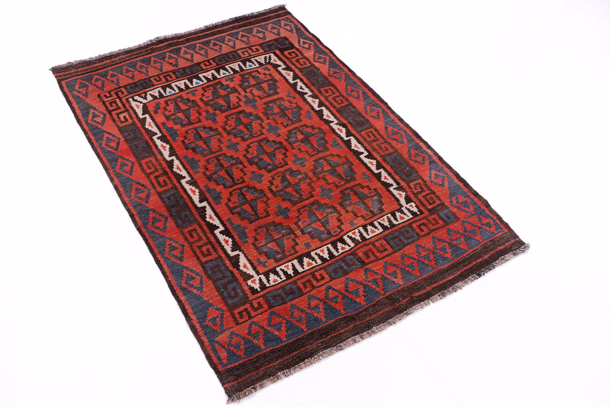 Nomad Charm kilim rug, red and dark blue geometric medallion, angled view
