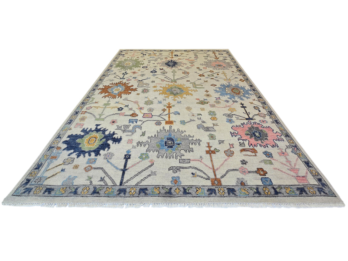 Oushak rug with light beige field, blue border, and multicolor geometric medallion pattern