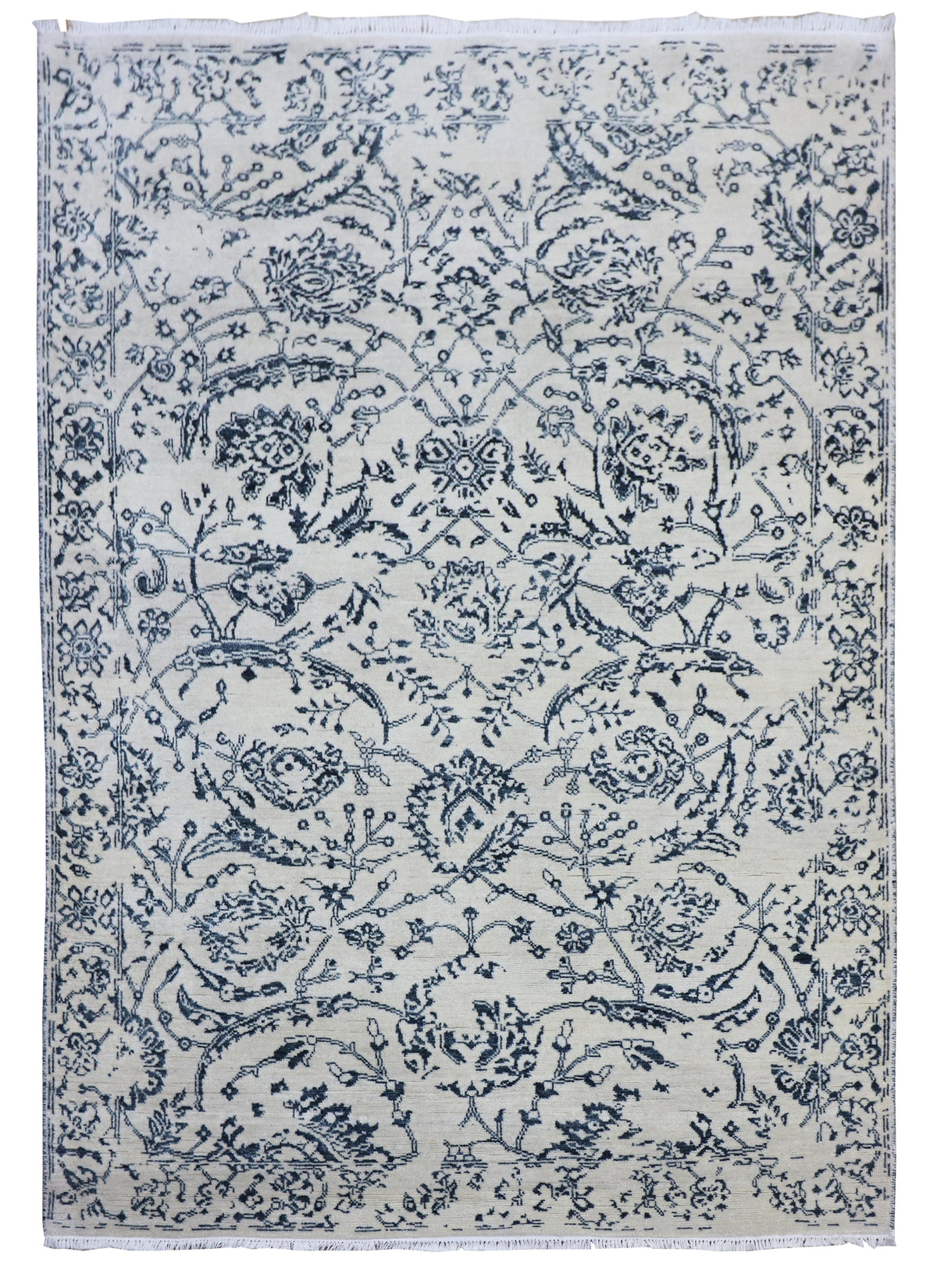 Delft blue and off-white area rug with dense floral scroll pattern and central medallion