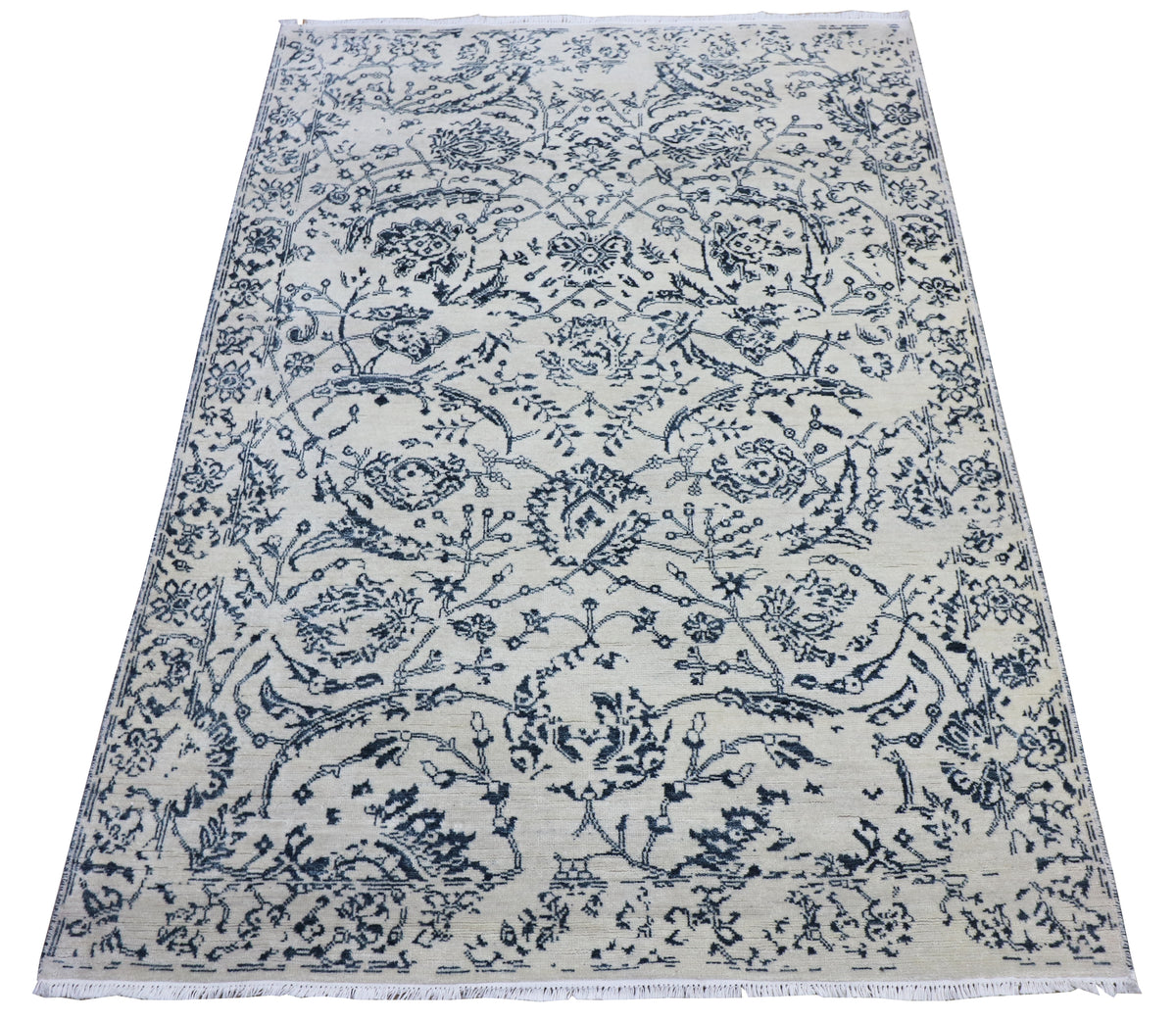 Delft blue and off-white area rug with ornate floral medallion pattern, flat-weave