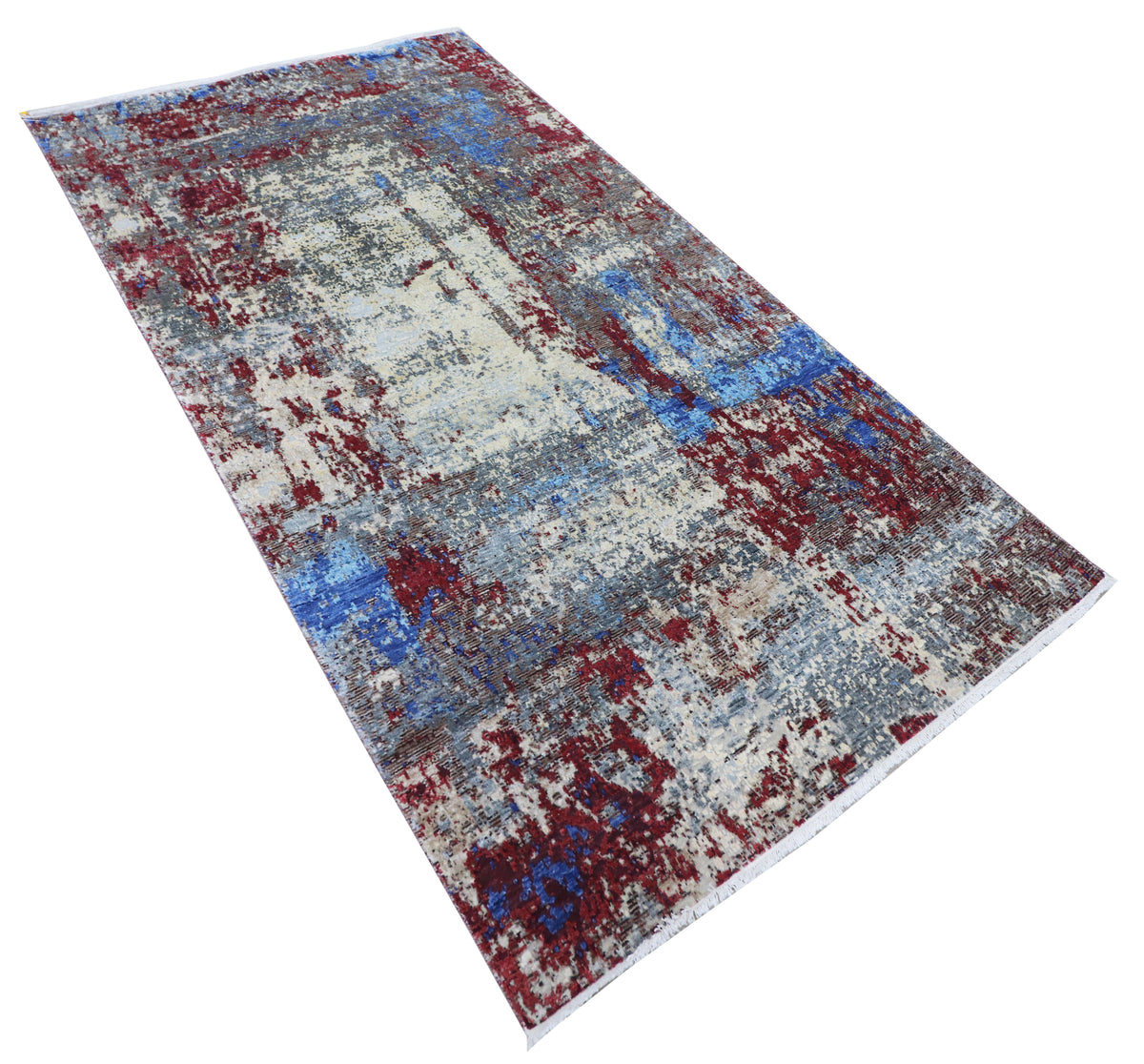 Rectangular abstract rug with layered blue, white, and crimson distress pattern