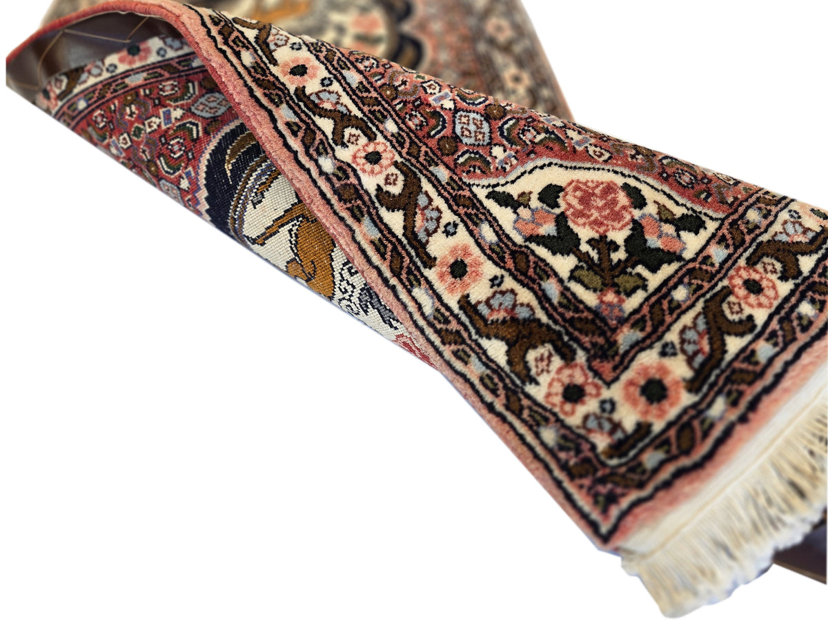 Runner rug corner view with multicolor pattern and cream fringe along the edge