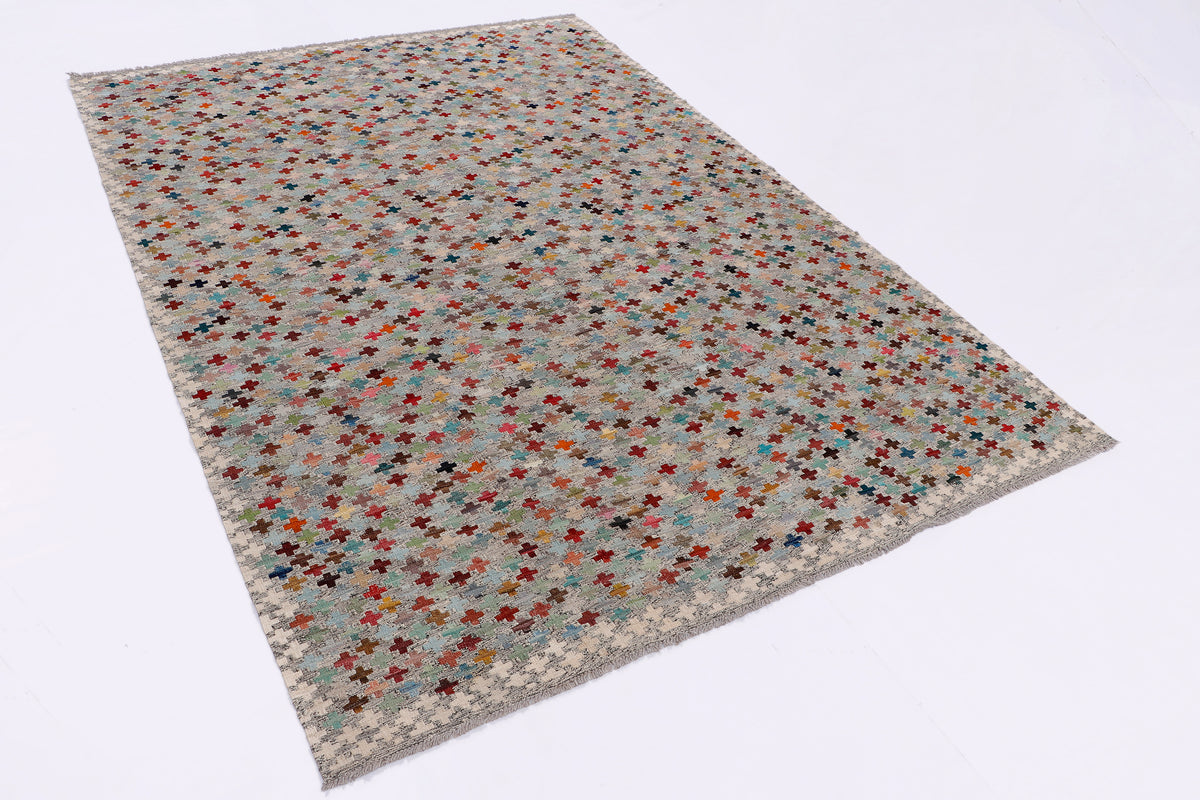Beige kilim area rug with multicolor cross motif, flatwoven geometric pattern.