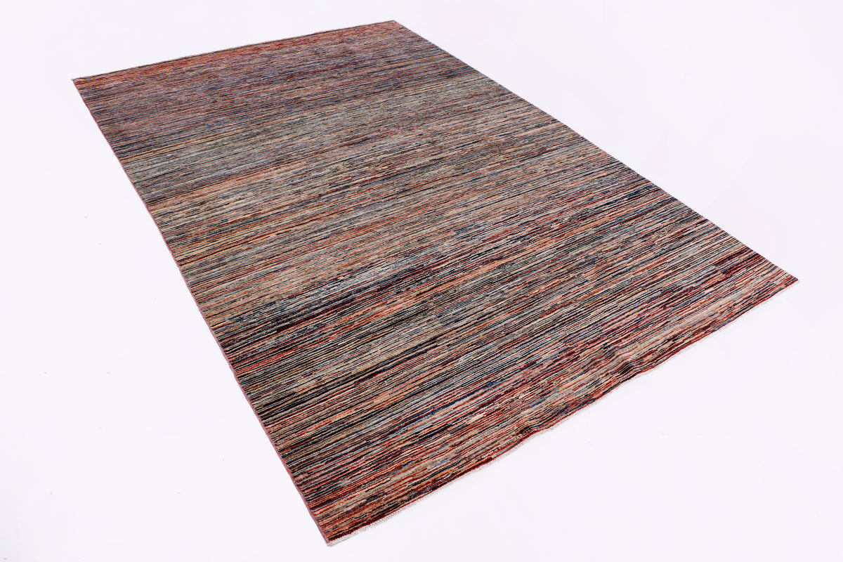 Striped brown area rug laid flat with multicolor maroon, blue, and cream bands