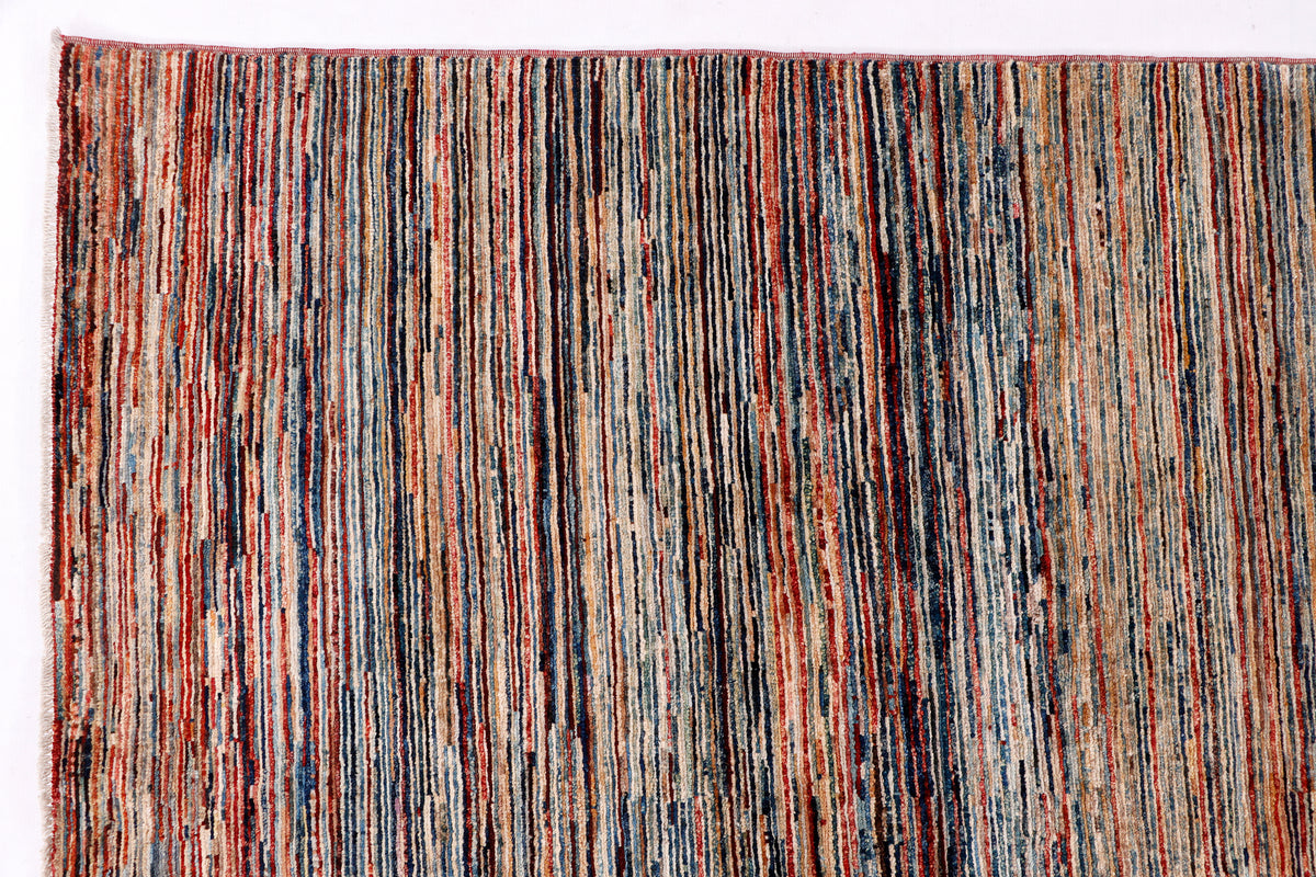 Striped rug close-up with multicolor vertical threads in brown, red, blue, and cream