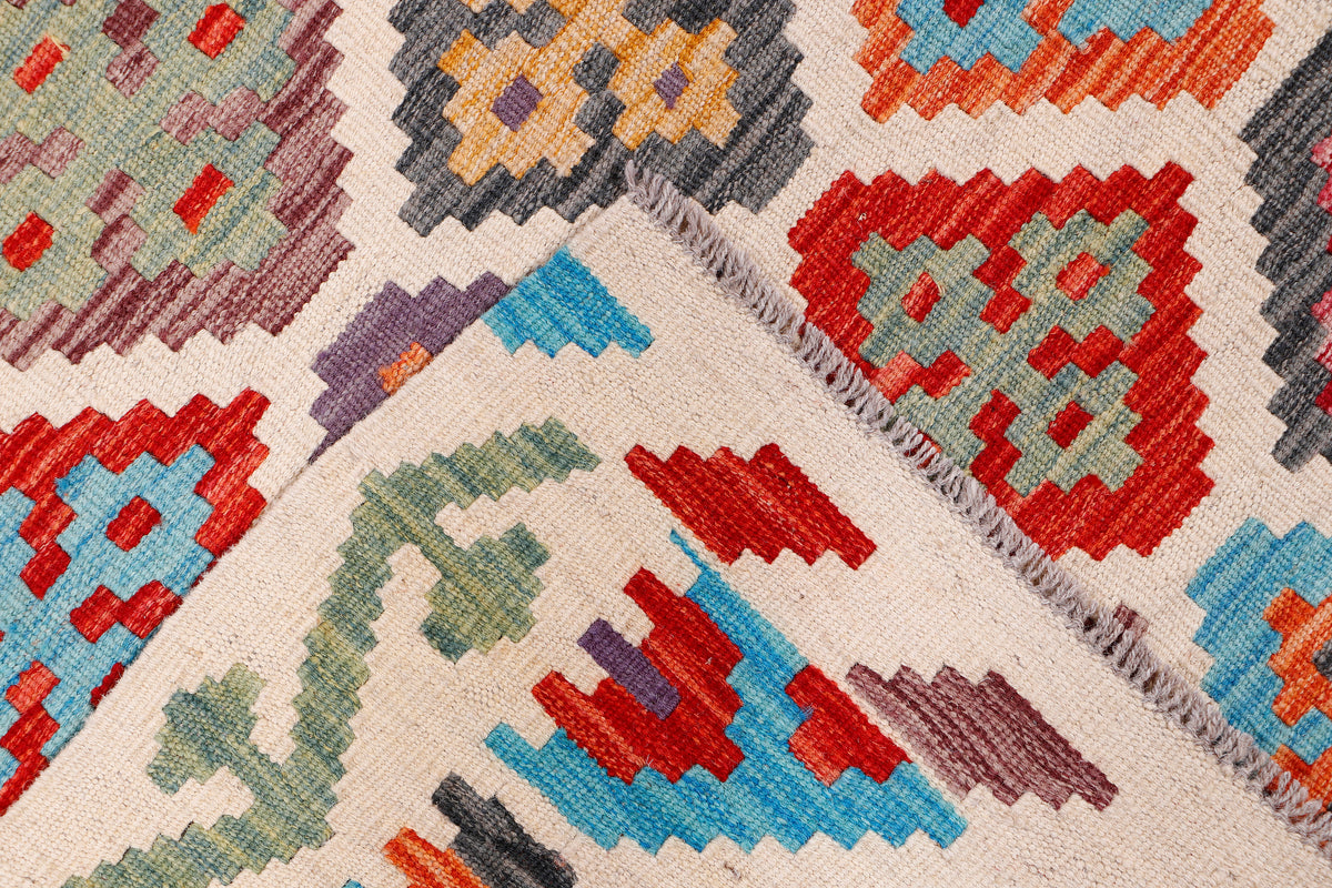 Kilim rug with multicolor geometric pattern and short fringe at the edge