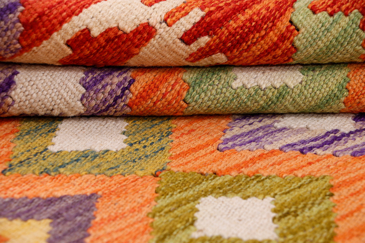 Close-up kilim rug with multicolor geometric shapes and stitched border detail