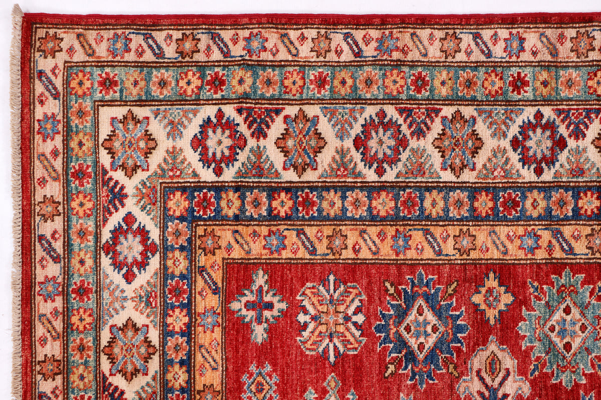 Red Kazak rug close-up: geometric medallions, patterned border, 198x155 cm