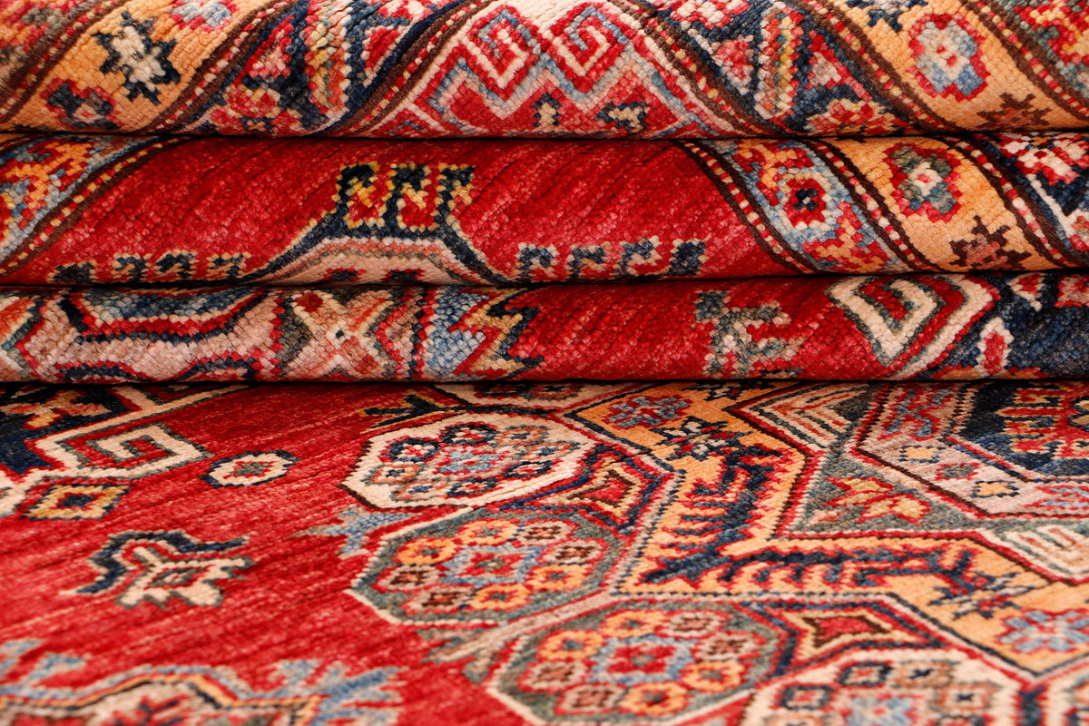 Close-up of red rug surface showing layered pattern and woven texture.