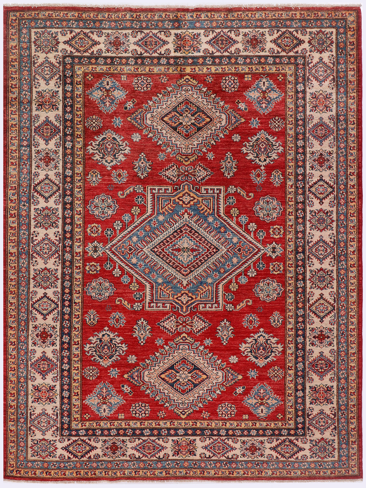 Red Kazak rug with central diamond medallion and floral rosette border in ivory
