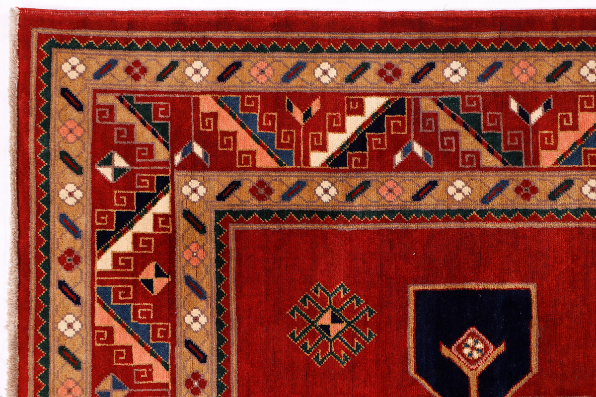 Red rug with multicolor geometric border and central diamond motifs